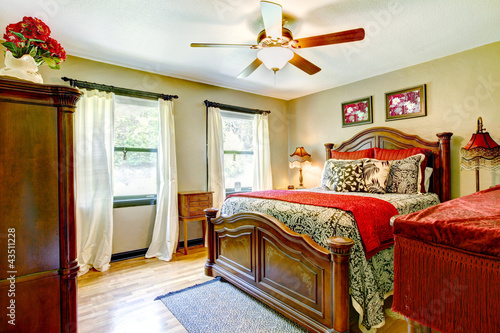 Photo: Elegant bedroom with red and gold interior. Elegant bedroom with red and gold interior.