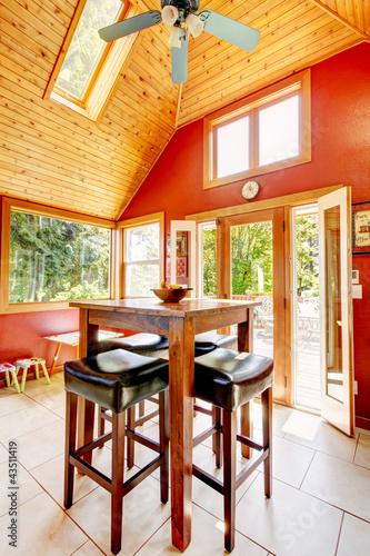 Photo: Luxury vaulted wood ceiling dining room with red walls. Luxury vaulted wood ceiling dining room with red walls.