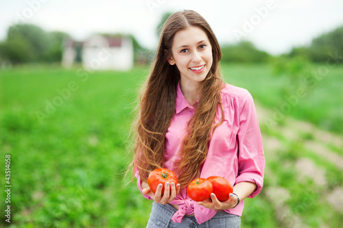Photo: Woman Holding Fresh Tomatoes Woman Holding Fresh Tomatoes