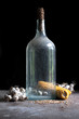 Foto: Old bottle of alcohol with maize, corn and garlic Old bottle of alcohol with maize, corn and garlic