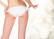 Photo: female backside, background with blurred lights female backside, background with blurred lights