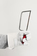 Foto: Work glove holding hand saw tool Work glove holding hand saw tool