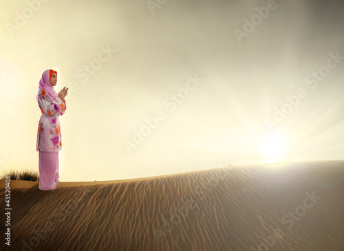 Photo: muslim woman praying on the desert muslim woman praying on the desert