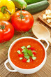 Gazpacho and ingredients on a table, vegetable soup