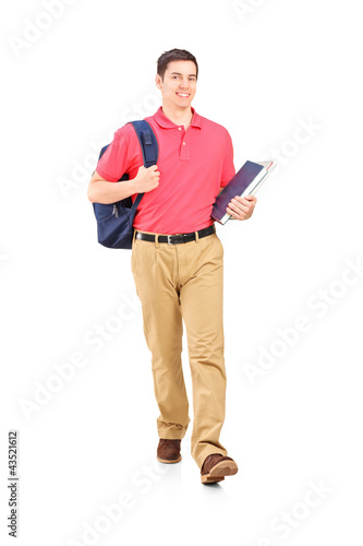 Foto: Full length portrait of a male student walking Full length portrait of a male student walking