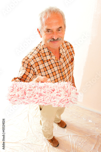 Photo: Senior man with paint roller Senior man with paint roller