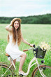 Foto: Woman on bicycle in field Woman on bicycle in field