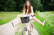 Foto: Woman riding bicycle with her legs in the air Woman riding bicycle with her legs in the air