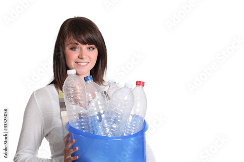 Photo: Girl sorting plastic bottles for garbage Girl sorting plastic bottles for garbage