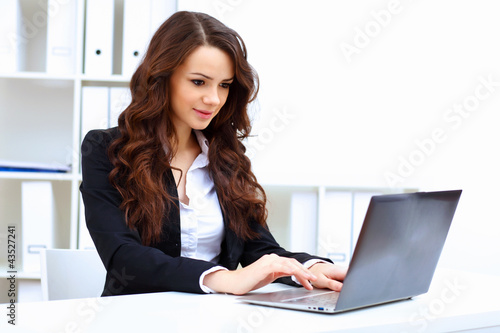 Photo: Young busines woman with notebook Young busines woman with notebook