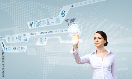 Photo: Businesswoman and touch screen technology Businesswoman and touch screen technology