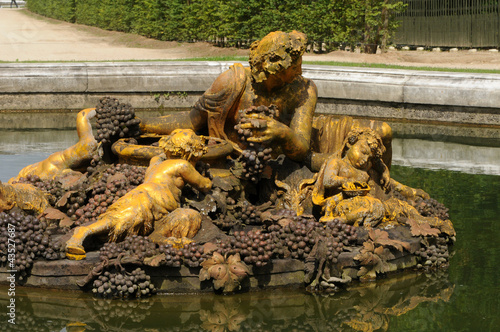 Photo: bronze statue in the park of Versailles Palace bronze statue in the park of Versailles Palace