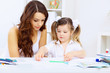 Little girl and her mother studying