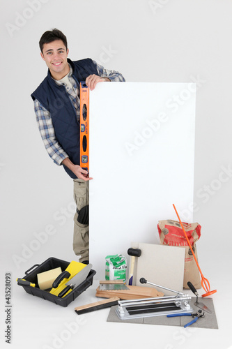 Photo: Tiler with spirit level and poster Tiler with spirit level and poster