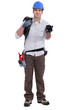 Building worker holding piggy bank on white background