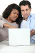 A couple looking at their laptop