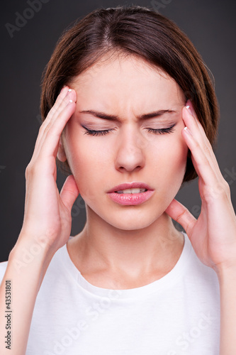 Photo: young woman have a headache young woman have a headache
