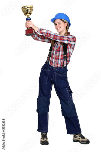 Photo: Female construction worker with a gold cup Female construction worker with a gold cup