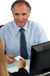 CEO handing business card to colleague