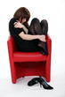 Woman curled up in a chair after a bad day