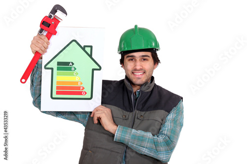 Photo: Tradesman holding a pipe wrench and an energy sign Tradesman holding a pipe wrench and an energy sign