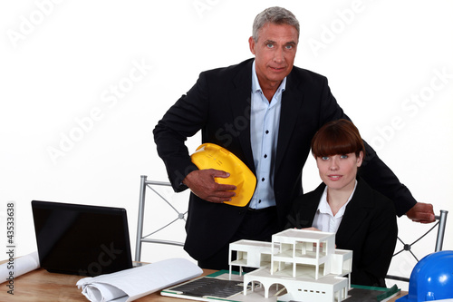Photo: female architect in office with male counterpart female architect in office with male counterpart