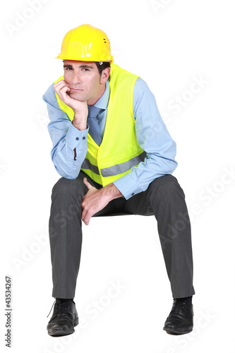 Photo: Bored engineer working on-site Bored engineer working on-site