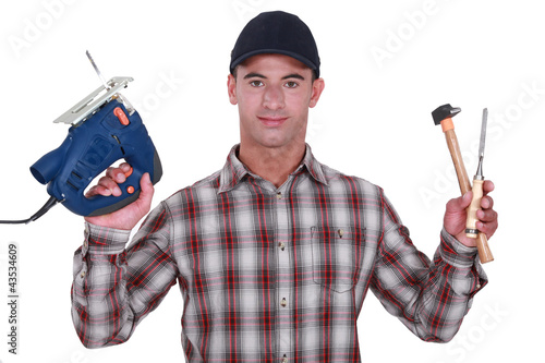 Photo: Man holding band-saw, hammer and chisel Man holding band-saw, hammer and chisel
