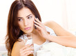 glass of water and phone in bed