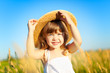 Beautiful little girl on the meadow in summer day
