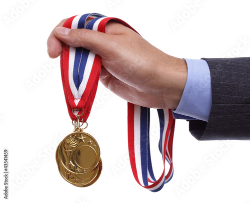 Photo: Businessman holding gold medal Businessman holding gold medal
