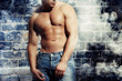 Foto: artwork male with a sexy man without a shirt standing against a artwork male with a sexy man without a shirt standing against a
