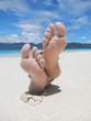 Sandy feet on a tropical beach