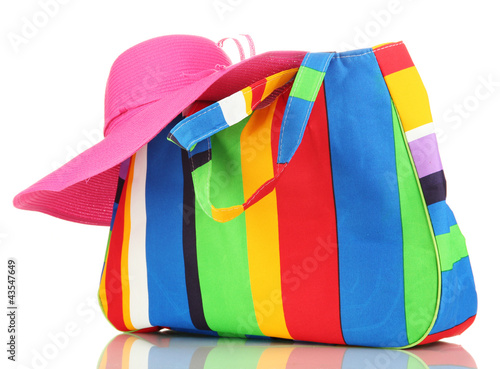 Photo: Beach bag with accessories isolated on white Beach bag with accessories isolated on white