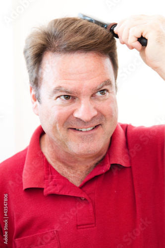 Photo: Man Brushing His Hair Man Brushing His Hair