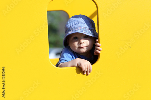Photo: Child in yellow toy house Child in yellow toy house