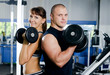 Foto: The woman with the trainer in sports club The woman with the trainer in sports club