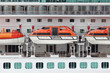 Orange lifeboats installed on beautiful white passenger liner