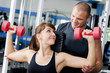 Foto: The woman with the trainer in sports club The woman with the trainer in sports club