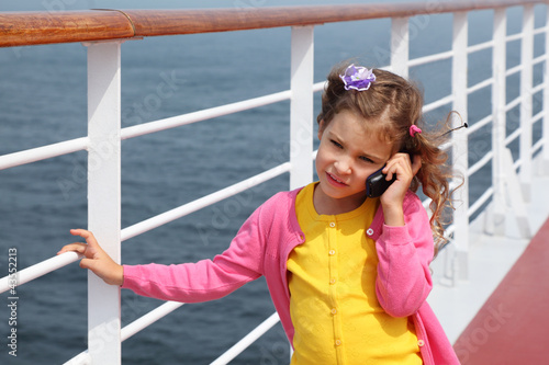 Photo: girl stands on board ship and talks by portable radio phone girl stands on board ship and talks by portable radio phone