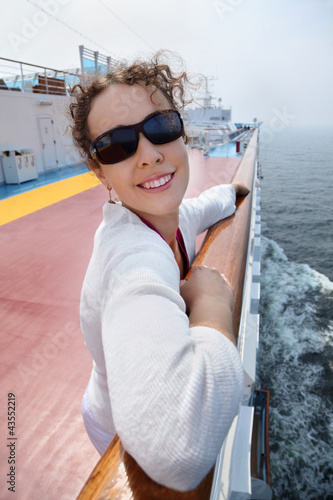 Photo: Beautiful woman stands on board of large ship, Beautiful woman stands on board of large ship,