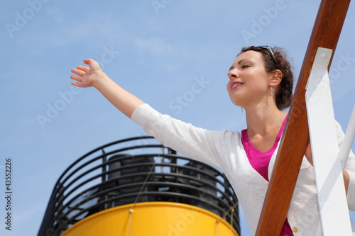Foto: Beautiful woman stands on board of large ship, Beautiful woman stands on board of large ship,