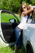 The beautiful girl stands near to white car