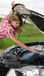 The beautiful girl repairs the car