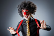 Businessman with clown wig and face paint