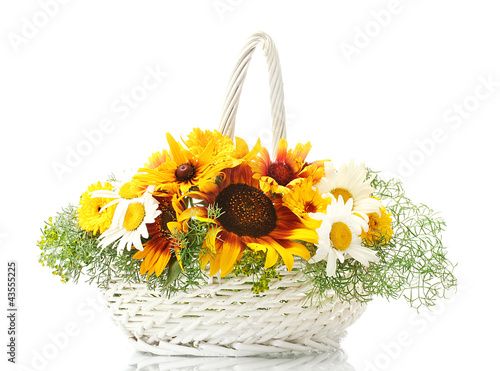 Photo: beautiful bouquet of bright wildflowers in basket, isolated beautiful bouquet of bright wildflowers in basket, isolated