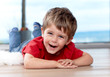 three years old boy on the floor, having fun