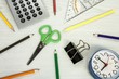 school composition, clock, pencils, calculator,  and scissors