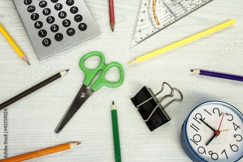 Photo: school composition, clock, pencils, calculator, and scissors school composition, clock, pencils, calculator, and scissors