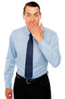 Surprised businessman with hand on mouth